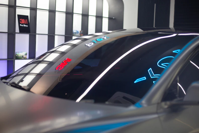 Finished tinted car glass seen in reflected light after installation.