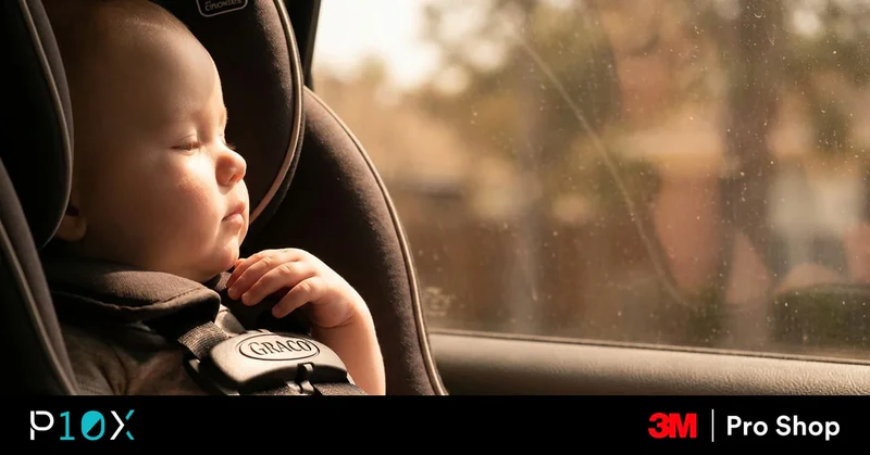 Baby in a back-seat child seat with afternoon sun through a tinted window showing if car tint protects a baby from the sun