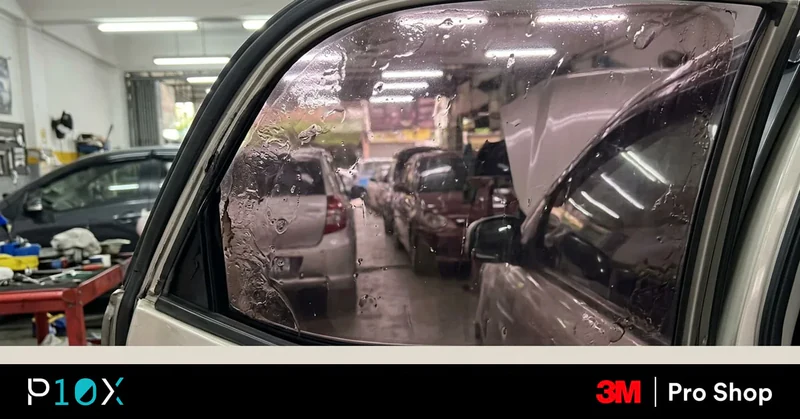 Retint car windows Malaysia close-up showing bubbling and discolouration on aging window tint film at a professional workshop