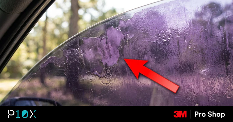 Car window showing why car tint turns purple with a red arrow pointing at the faded film