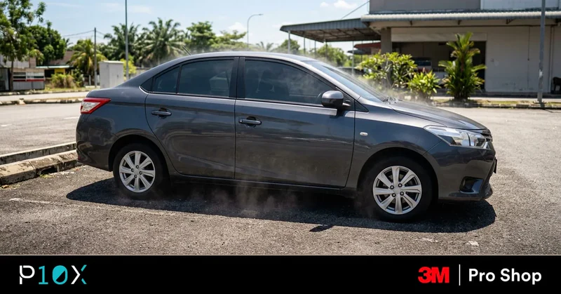 Car still hot after tint in Malaysia showing a tinted sedan parked under direct sunlight with heat visible inside the cabin